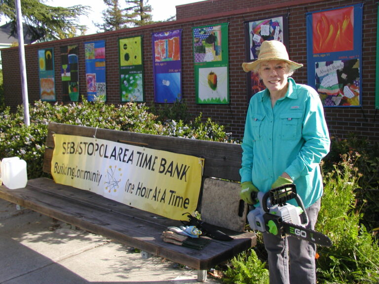 Time Bank volunteers clean up the gardens around the library and city hall