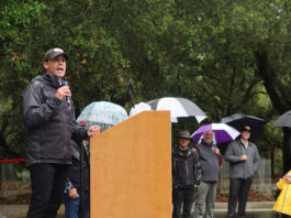 Mike McGuire giving speech in the rain