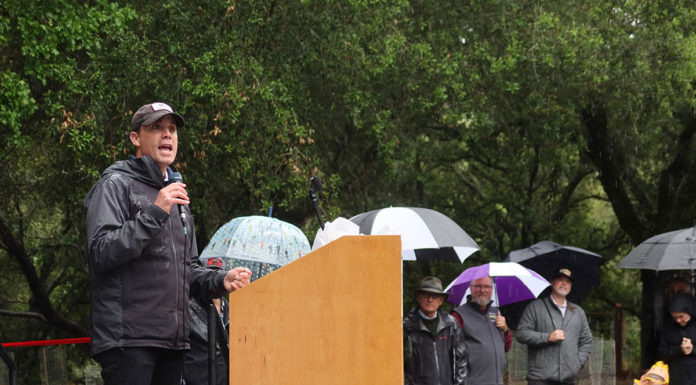 Mike McGuire giving speech in the rain