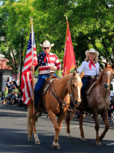 Horses and riders with flags