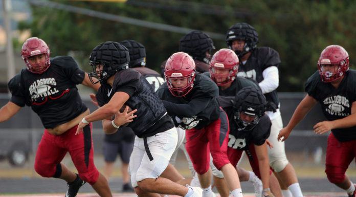 Football action in scrimmage