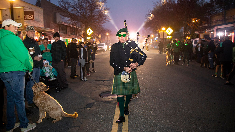 Bagpiper leading pre-dawn parade